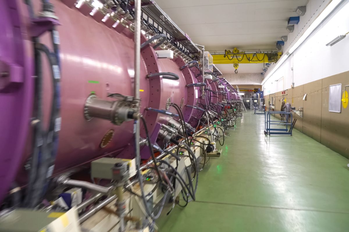 A large purple pipe situated in a room filled with other pipes, emphasizing washer heater issues that can reduce energy efficiency.