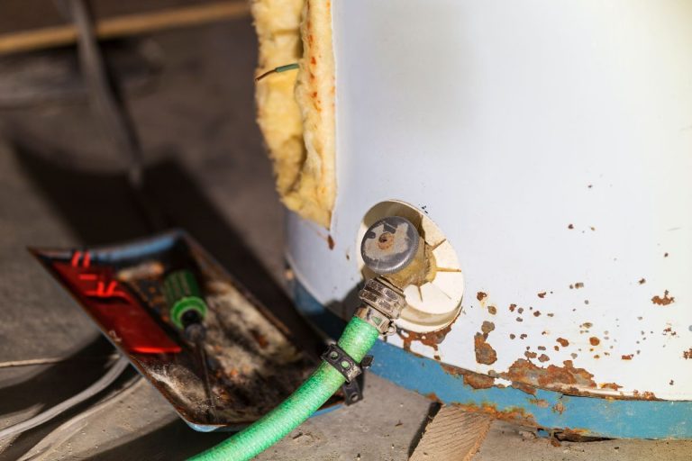 A tool is used to repair a water heater, highlighting issues related to washer heater problems.