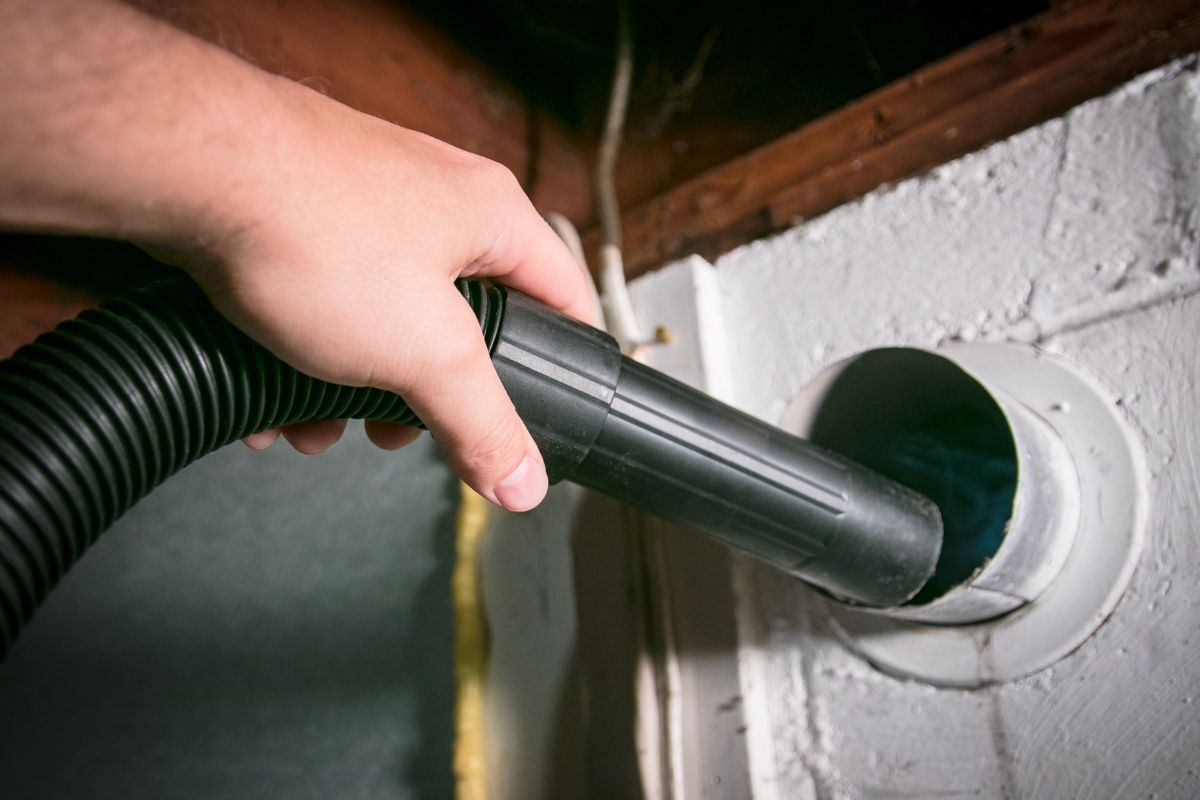  A person operates a dryer to remove dust , ensuring a clean and tidy environment.
